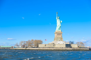 Fototapeta premium The statue of Liberty at a sunny day with blue sky, New York City, USA