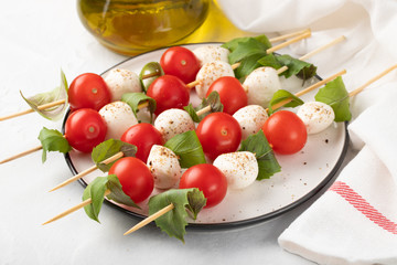 Caprese salad - skewer with tomato, mozzarella and basil, italian food and healthy vegetarian diet...