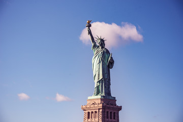 Fototapeta premium The statue of Liberty at a sunny day with blue sky, New York City, USA