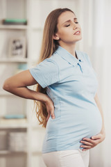 Young Pregnant Girl Suffering From Pain at Home.