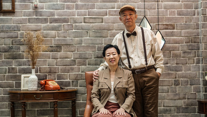 Rich Asian senior couple vintage fashion in luxury house