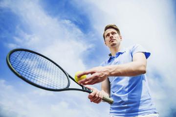 Young Guy in Shirt Ready to Serve on Tennis Court
