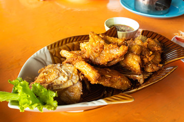 Fried Pomegranate fish With seafood sauce and vegetables.