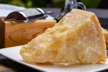 Traditional italian food - 36 months aged in caves Italian parmesan hard cheese from Parmigiano-Reggiano, Italy © barmalini