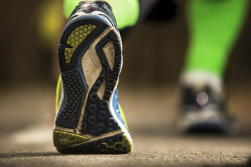 Ready to go! low angle photo of shoe of male athlete on the tarmac, preparing for a run. autumn  morning