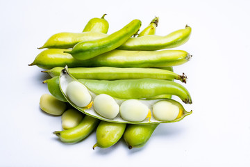 New harvest of healthy vegetables, green fresh raw big broad beans close up isolated on white background