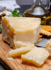 Traditional italian food - 36 months aged in caves Italian parmesan hard cheese from Parmigiano-Reggiano, Italy