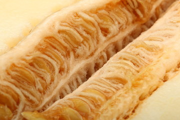 A view of a ripe melon with seeds cut in half close-up