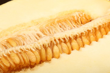 A view of a ripe melon with seeds cut in half close-up