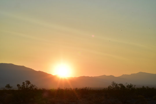 long exposure photos of the sun rising over the ridge of the Spring Mountains in the Mojave Desert town of Pahrump, Nevada, USA © mariekazalia