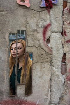 Conceptal picture made in the jewish ghetto of Cracow, Poland. Girls in broken mirror.
