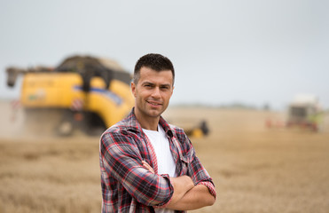 Farmer standing in field during harvest