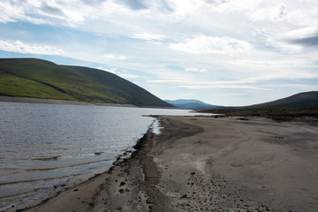This is the old Dingwall to Ullapool road that was submerged on the creation of Loch Glascarnoch.  The road has reappeared due to low rain.  This shows the road entering the loch.