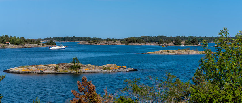 A  panoramic view of the wonderful archipelago of St. Anna in the Baltic Sea, Sweden with a boat with sighseeing tourists and some pleasure boats with people spending their free time in the archipelag