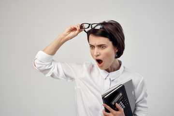 business woman in glasses surprised with glasses documents