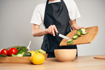 cook prepares to eat cutting vegetables