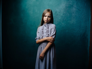 girl in a blue dress on a green background