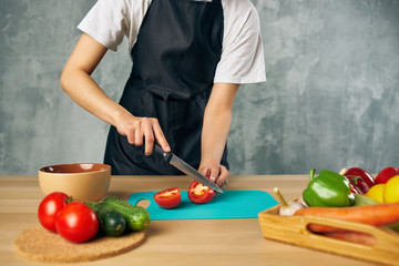 cook cutting vegetables cooking