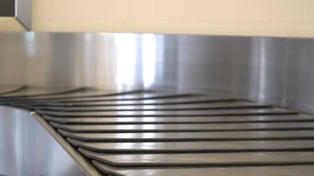 Professional video of empty luggage carousel at the airport in 4K and slow motion 60fps