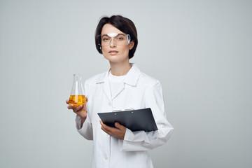 laboratory assistant with flask chemicals