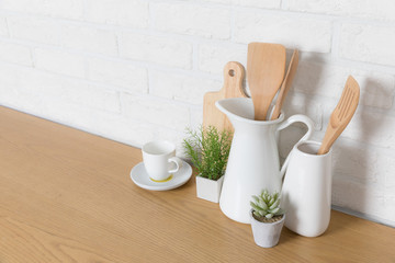 Kitchen utensils and dishware on wooden shelf. Kitchen interior background