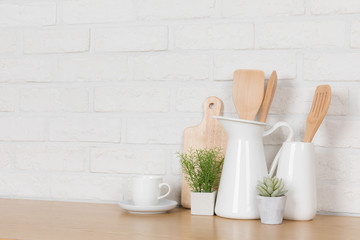 Kitchen utensils and dishware on wooden shelf. Kitchen interior background