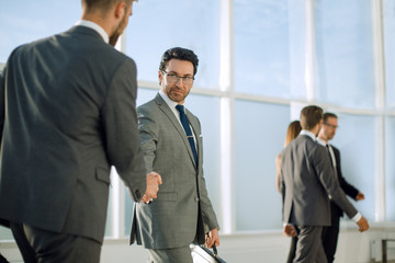 Fototapeta premium businessmen handshaking after striking deal