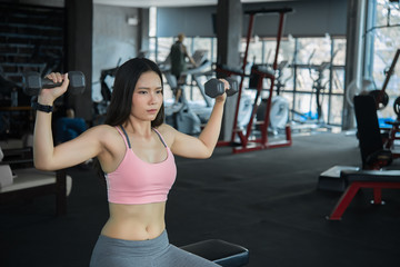 Fototapeta na wymiar Beautiful asian woman play fitness in the gym,Thailand girl has a slim body,Time for exercise,People love heathy