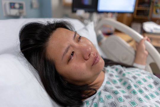 Crying Asian Mother During Labor And Delivery