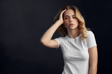 blonde woman in white t-shirt logo