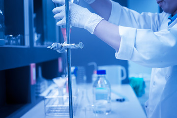 Fototapeta premium Scientist mix chemicals with The shake machine Before the experiment.Mixture laced with samples into test tubes,Thailand scientist working in the lab