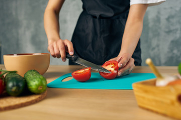 woman cutting vegetables in kitchen