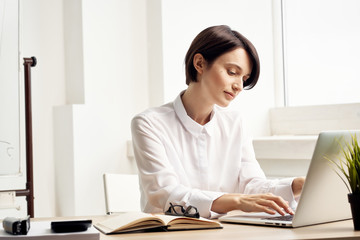 business woman with glasses sitting in the office