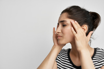 woman holding her head with eyes closed headache treatment health