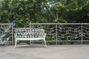 White metal park bench in the park