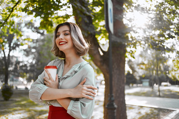 woman with coffee nature park