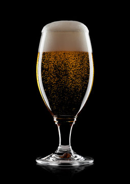 Cold glass of lager beer with foam and bubbles
