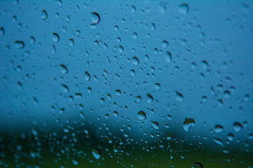 Road view through car windshield with rain drops, Driving in rain.