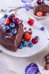 chocolate cake with fresh berries, on white background.Sweet dessert. Copy space,