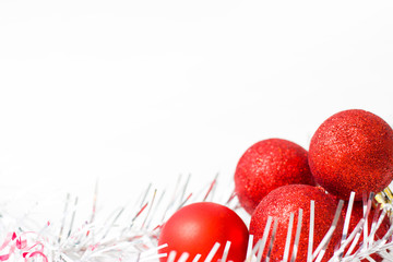 Christmas and new year card with red balls with silver decorations on white background. copyspace - holidays, winter and celebration concept