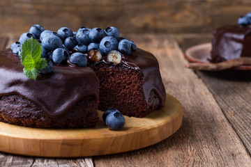Chocolate cake topped with chocolate glaze and blueberries
