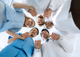 Medical staff standing in a circle at a meeting