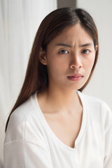 unhappy angry upset asian woman portrait with frustrated, bored, disgusted face; portrait of negative unhappy angry asian woman looking up; young adult asian persian or asian middle east woman model
