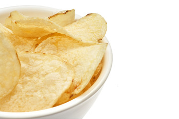Delicious golden potato chips in a white bowl isolated on white background.