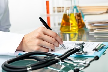 Closeup of a Doctor Filling Out a Medical Form