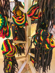 many hats with the colors of the Jamaican flag for sale in the costume shop