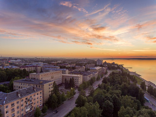Aerial lakeside cityscape view at golden hour after sunset