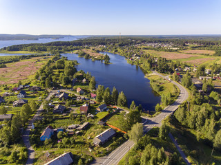 Fototapeta premium Aerial view of beautiful lake and village around it