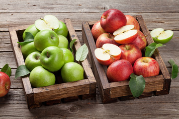 Green and red apples in wooden box