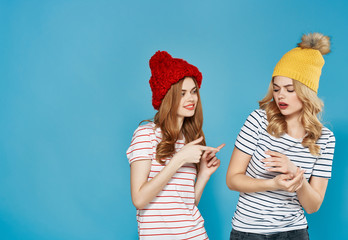 girlfriends women in hats on a blue background